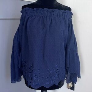 Trina Turk black top with cutouts on bottom of shirt and cuffs size Small